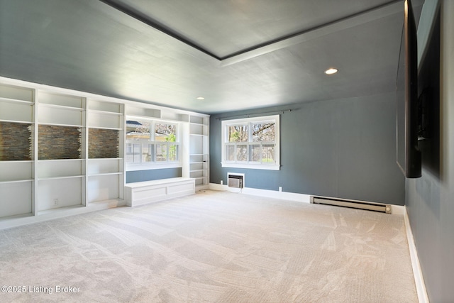 carpeted spare room featuring recessed lighting, a baseboard heating unit, and baseboards