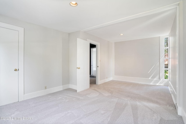 spare room featuring recessed lighting, baseboards, and carpet floors