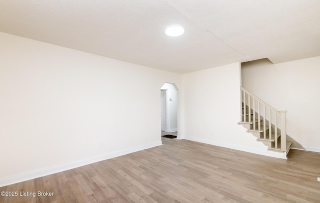 5512 Mae Ct, Louisville, KY 40214 - unfurnished room with light wood-type flooring, arched walkways, baseboards, and stairway