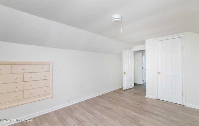 5512 Mae Ct, Louisville, KY 40214 - interior space featuring vaulted ceiling, light wood-style floors, baseboards, and a textured ceiling