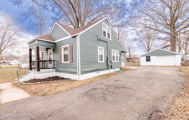 5512 Mae Ct, Louisville, KY 40214 - view of home's exterior with an outbuilding, driveway, a shingled roof, crawl space, and a detached garage