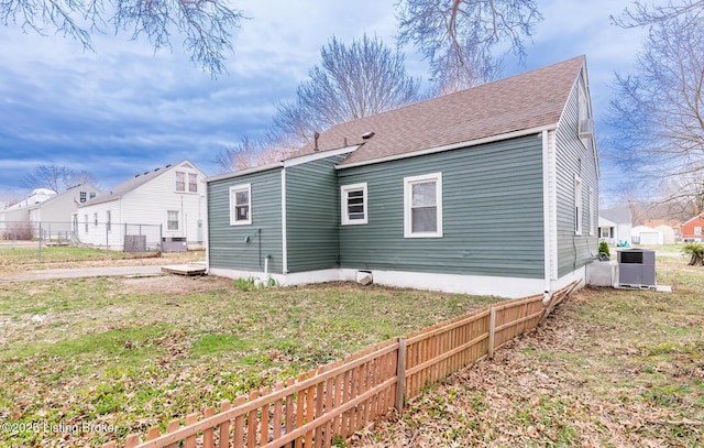 5512 Mae Ct, Louisville, KY 40214 - rear view of property with central AC unit, a shingled roof, a yard, and fence