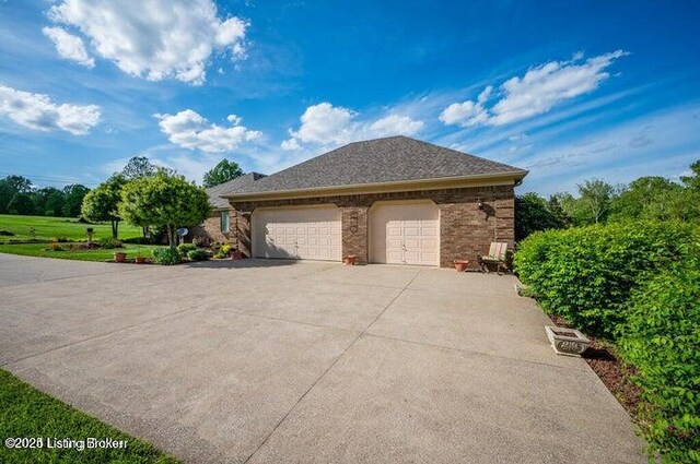 360 Rockcastle Villa, Shepherdsville, KY 40165 - view of side of property with driveway, an attached garage, and brick siding