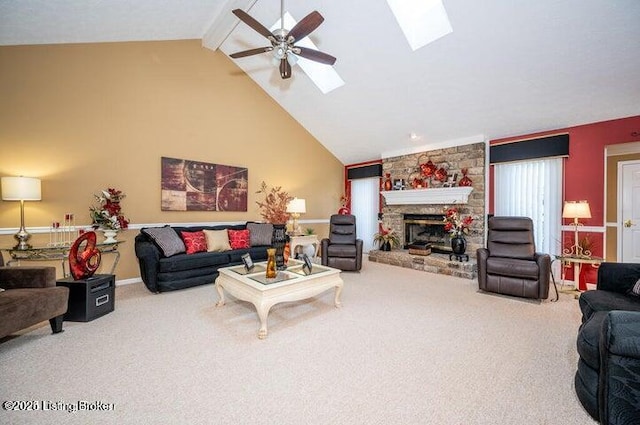 360 Rockcastle Villa, Shepherdsville, KY 40165 - carpeted living room featuring a skylight, ceiling fan, beamed ceiling, a stone fireplace, and high vaulted ceiling