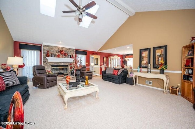 360 Rockcastle Villa, Shepherdsville, KY 40165 - living room featuring ceiling fan, carpet floors, beamed ceiling, a skylight, and a stone fireplace