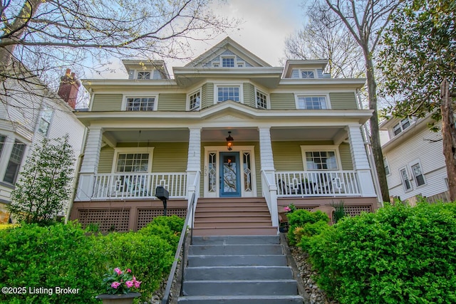 victorian house featuring a porch and stairs