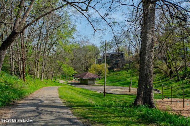 view of community with driveway, a gazebo, and a lawn