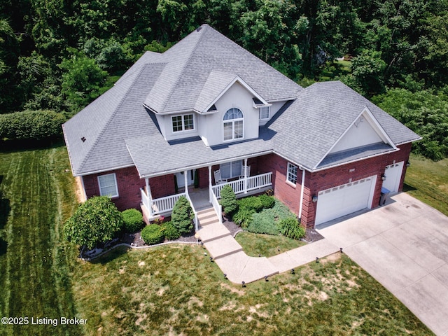 7603 Cottage Cove Way, Louisville, KY 40214 - view of front of home with covered porch, a garage, concrete driveway, and brick siding