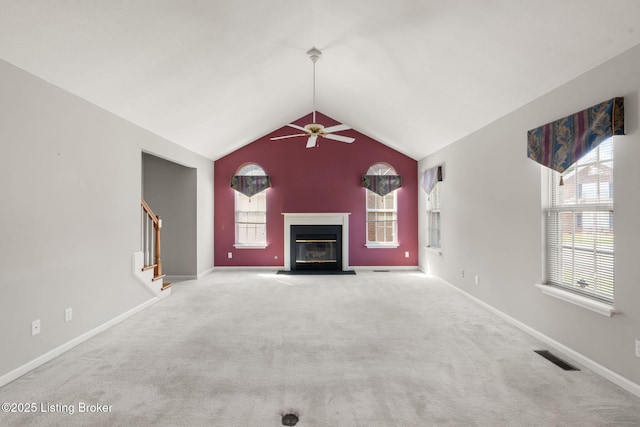 1501 Eagle Nest Way, Lyndon, KY 40222 - unfurnished living room featuring a ceiling fan, a glass covered fireplace, carpet flooring, lofted ceiling, and plenty of natural light
