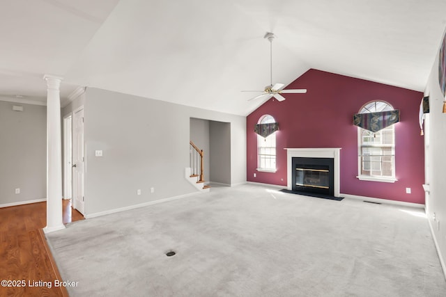 1501 Eagle Nest Way, Lyndon, KY 40222 - unfurnished living room with decorative columns, a ceiling fan, a fireplace with flush hearth, stairway, and high vaulted ceiling