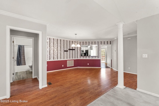 1501 Eagle Nest Way, Lyndon, KY 40222 - unfurnished dining area featuring ornate columns, ornamental molding, wood finished floors, baseboards, and a chandelier