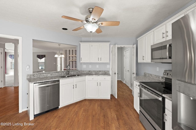 1501 Eagle Nest Way, Lyndon, KY 40222 - kitchen with stainless steel appliances, a sink, a ceiling fan, and wood finished floors