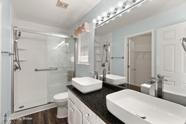 1501 Eagle Nest Way, Lyndon, KY 40222 - full bath with a shower stall, wood finished floors, toilet, a walk in closet, and double vanity