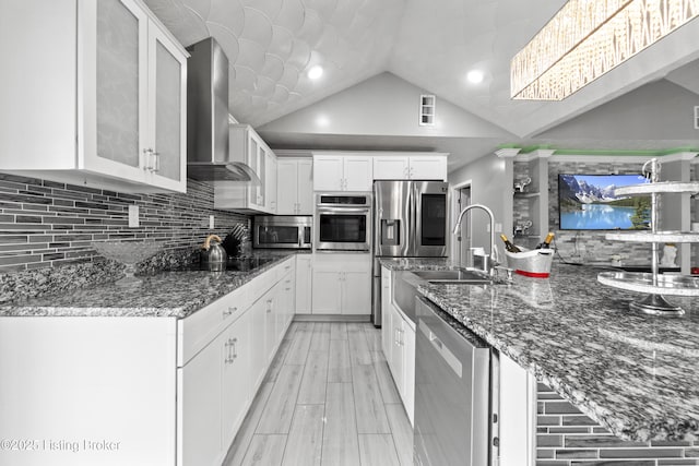 6301 Southside Dr, Louisville, KY 40214 - kitchen with stainless steel appliances, lofted ceiling, tasteful backsplash, and wall chimney exhaust hood