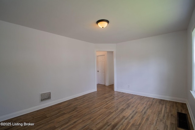 1301 Central Ave, Louisville, KY 40215 - unfurnished room with dark wood-type flooring, visible vents, and baseboards