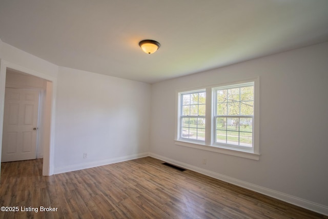 1301 Central Ave, Louisville, KY 40215 - unfurnished room featuring dark wood-style flooring, visible vents, and baseboards