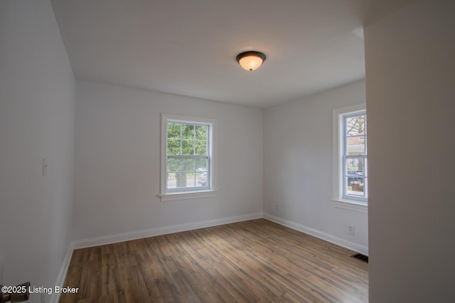 1301 Central Ave, Louisville, KY 40215 - spare room featuring visible vents, baseboards, and wood finished floors