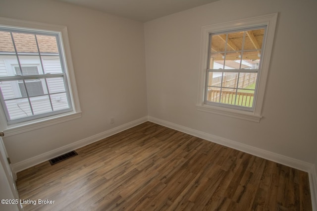 1301 Central Ave, Louisville, KY 40215 - empty room featuring visible vents, baseboards, and wood finished floors