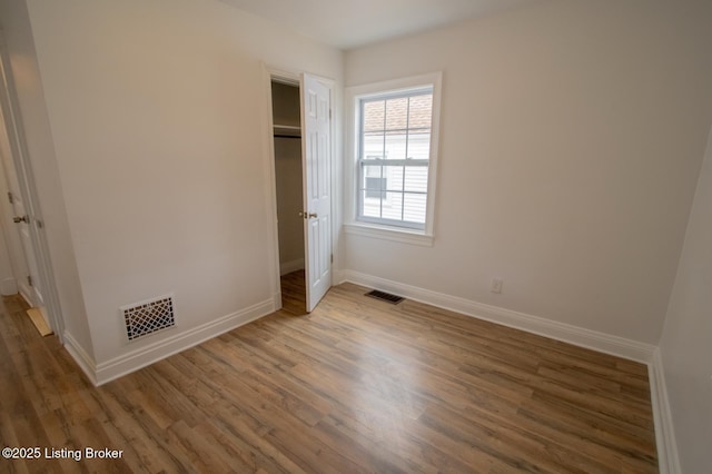 1301 Central Ave, Louisville, KY 40215 - unfurnished bedroom featuring visible vents, baseboards, and wood finished floors
