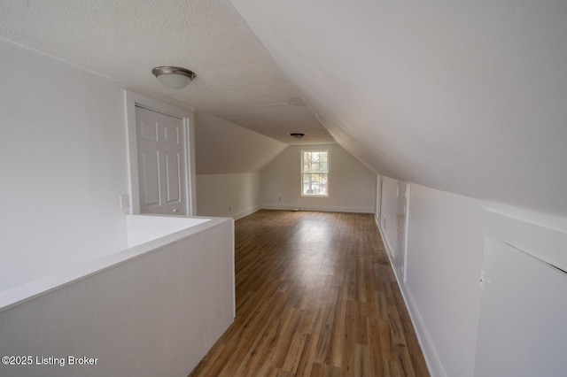1301 Central Ave, Louisville, KY 40215 - bonus room featuring baseboards, a textured ceiling, wood finished floors, and lofted ceiling