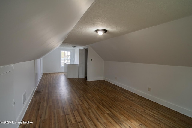 1301 Central Ave, Louisville, KY 40215 - bonus room with baseboards, a textured ceiling, visible vents, lofted ceiling, and wood finished floors