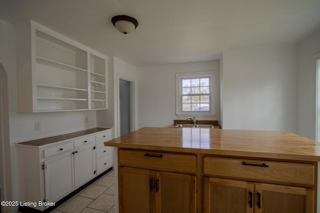 1301 Central Ave, Louisville, KY 40215 - kitchen with butcher block countertops, light tile patterned floors, a sink, and open shelves