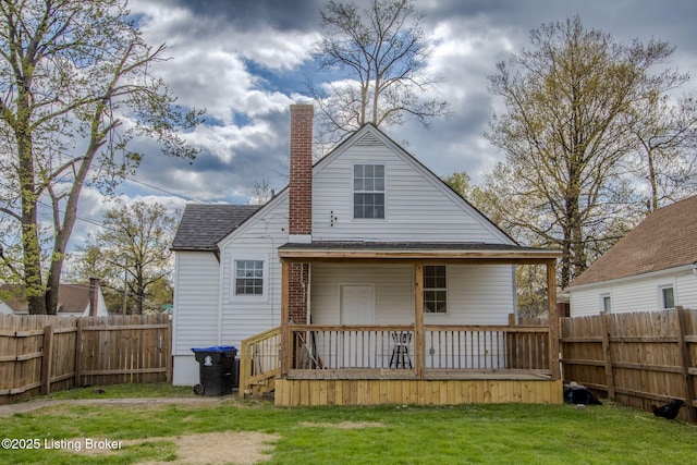1301 Central Ave, Louisville, KY 40215 - rear view of property with a chimney, a fenced backyard, a deck, and a lawn