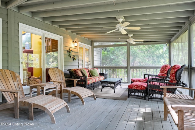 sunroom featuring a wealth of natural light, outdoor lounge area, and a ceiling fan