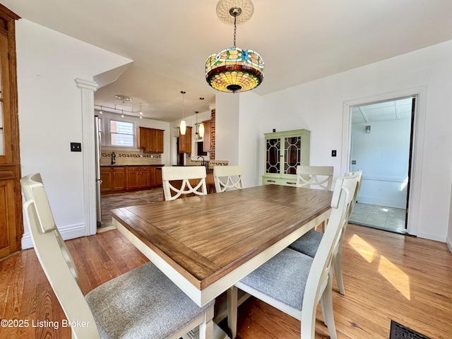 dining room featuring light wood-style flooring and attic access
