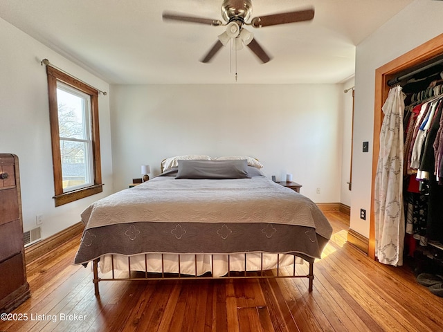 bedroom with hardwood / wood-style flooring, baseboards, and ceiling fan