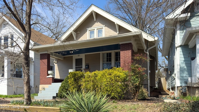 view of front of property with brick siding and a porch