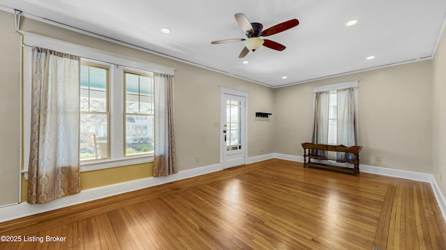 foyer featuring hardwood / wood-style floors, baseboards, recessed lighting, ornamental molding, and ceiling fan