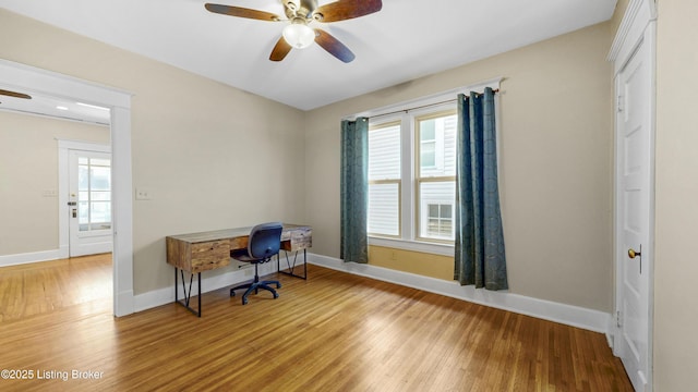 office space featuring light wood-type flooring, baseboards, and ceiling fan