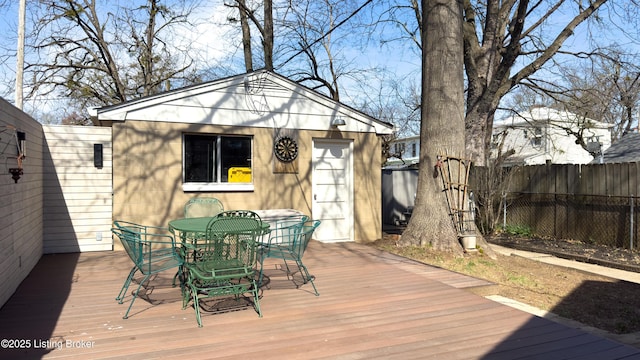 wooden deck with outdoor dining space and fence