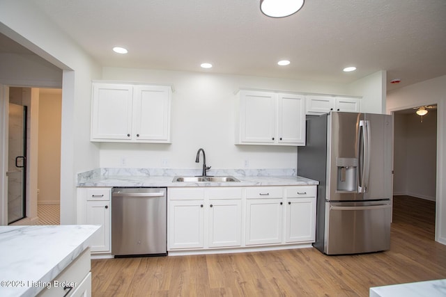 3833 Jupiter Rd, Louisville, KY 40218 - kitchen featuring stainless steel appliances, a sink, white cabinetry, light stone countertops, and recessed lighting