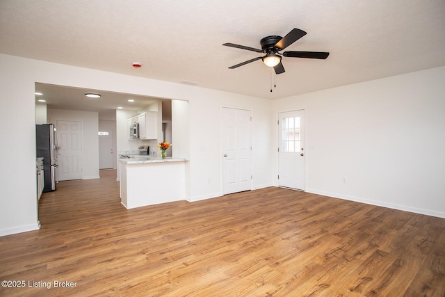 3833 Jupiter Rd, Louisville, KY 40218 - unfurnished living room featuring wood finished floors, ceiling fan, baseboards, and recessed lighting