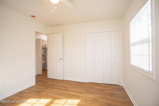 3833 Jupiter Rd, Louisville, KY 40218 - unfurnished bedroom with light wood-type flooring, baseboards, and a closet