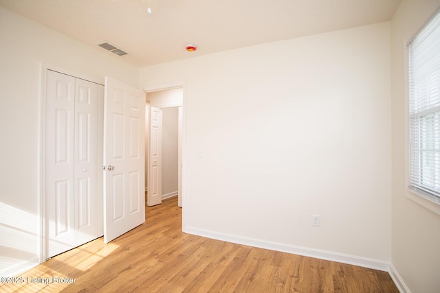 3833 Jupiter Rd, Louisville, KY 40218 - unfurnished bedroom featuring light wood finished floors, a closet, and baseboards