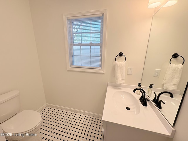 3833 Jupiter Rd, Louisville, KY 40218 - half bathroom featuring toilet, vanity, and baseboards