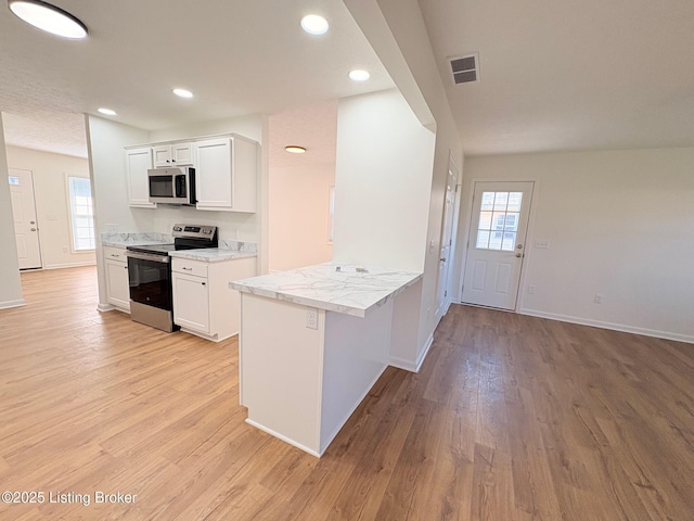 3833 Jupiter Rd, Louisville, KY 40218 - kitchen featuring appliances with stainless steel finishes, light wood-style flooring, healthy amount of natural light, white cabinets, and recessed lighting