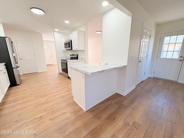 3833 Jupiter Rd, Louisville, KY 40218 - kitchen with stainless steel appliances, light wood-type flooring, white cabinets, baseboards, and recessed lighting