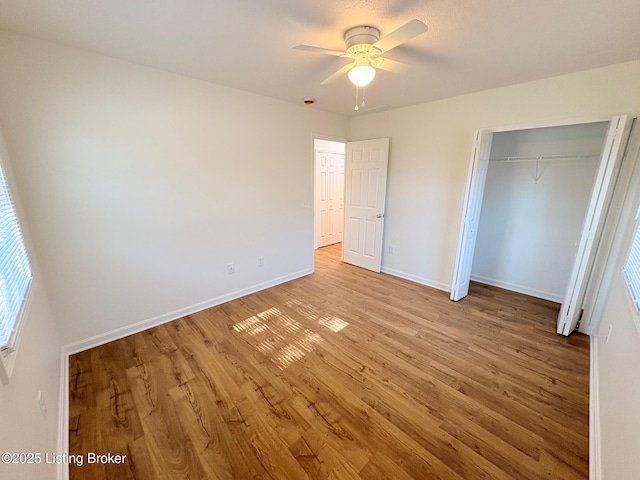 3833 Jupiter Rd, Louisville, KY 40218 - unfurnished bedroom featuring light wood finished floors, baseboards, a closet, and a ceiling fan