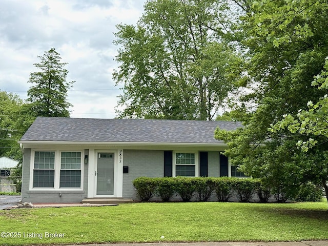 3833 Jupiter Rd, Louisville, KY 40218 - view of front facade featuring a front lawn, roof with shingles, and brick siding