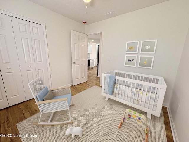 3833 Jupiter Rd, Louisville, KY 40218 - bedroom with wood finished floors, a closet, and baseboards