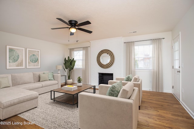 3833 Jupiter Rd, Louisville, KY 40218 - living room featuring a fireplace, wood finished floors, ceiling fan, and baseboards