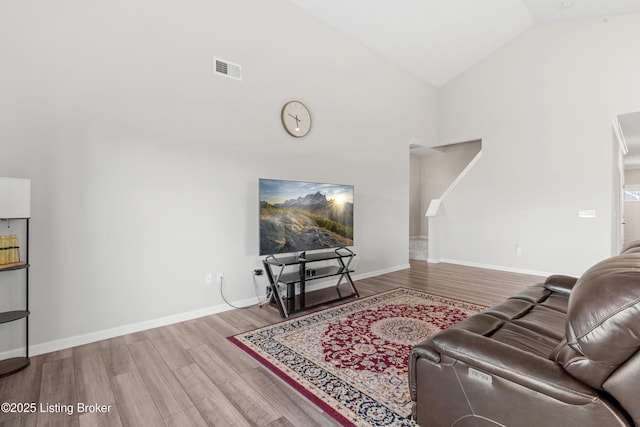 8806 Warbler Branch Way, Louisville, KY 40229 - living room featuring visible vents, baseboards, high vaulted ceiling, and wood finished floors