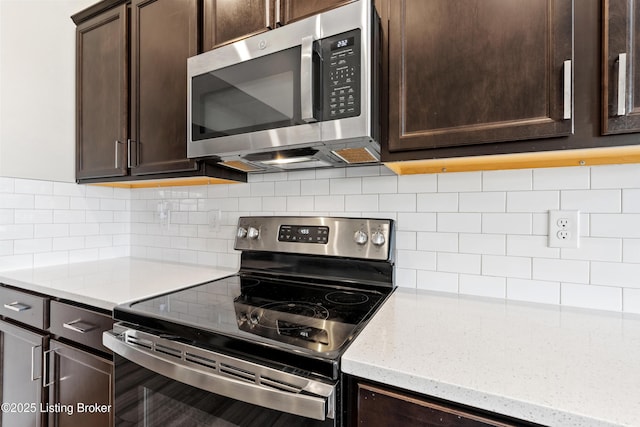 8806 Warbler Branch Way, Louisville, KY 40229 - kitchen featuring dark brown cabinets, decorative backsplash, light stone countertops, and appliances with stainless steel finishes