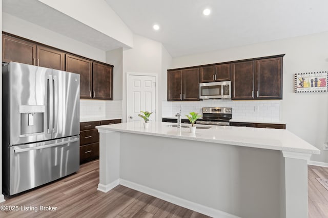 8806 Warbler Branch Way, Louisville, KY 40229 - kitchen featuring a sink, stainless steel appliances, light wood-style floors, and dark brown cabinetry