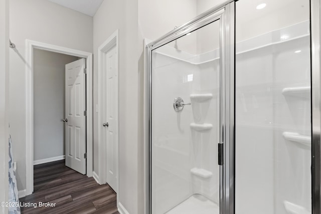 8806 Warbler Branch Way, Louisville, KY 40229 - bathroom with a stall shower, baseboards, and wood finished floors