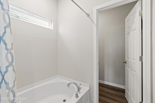 8806 Warbler Branch Way, Louisville, KY 40229 - bathroom featuring wood finished floors, a tub, and baseboards